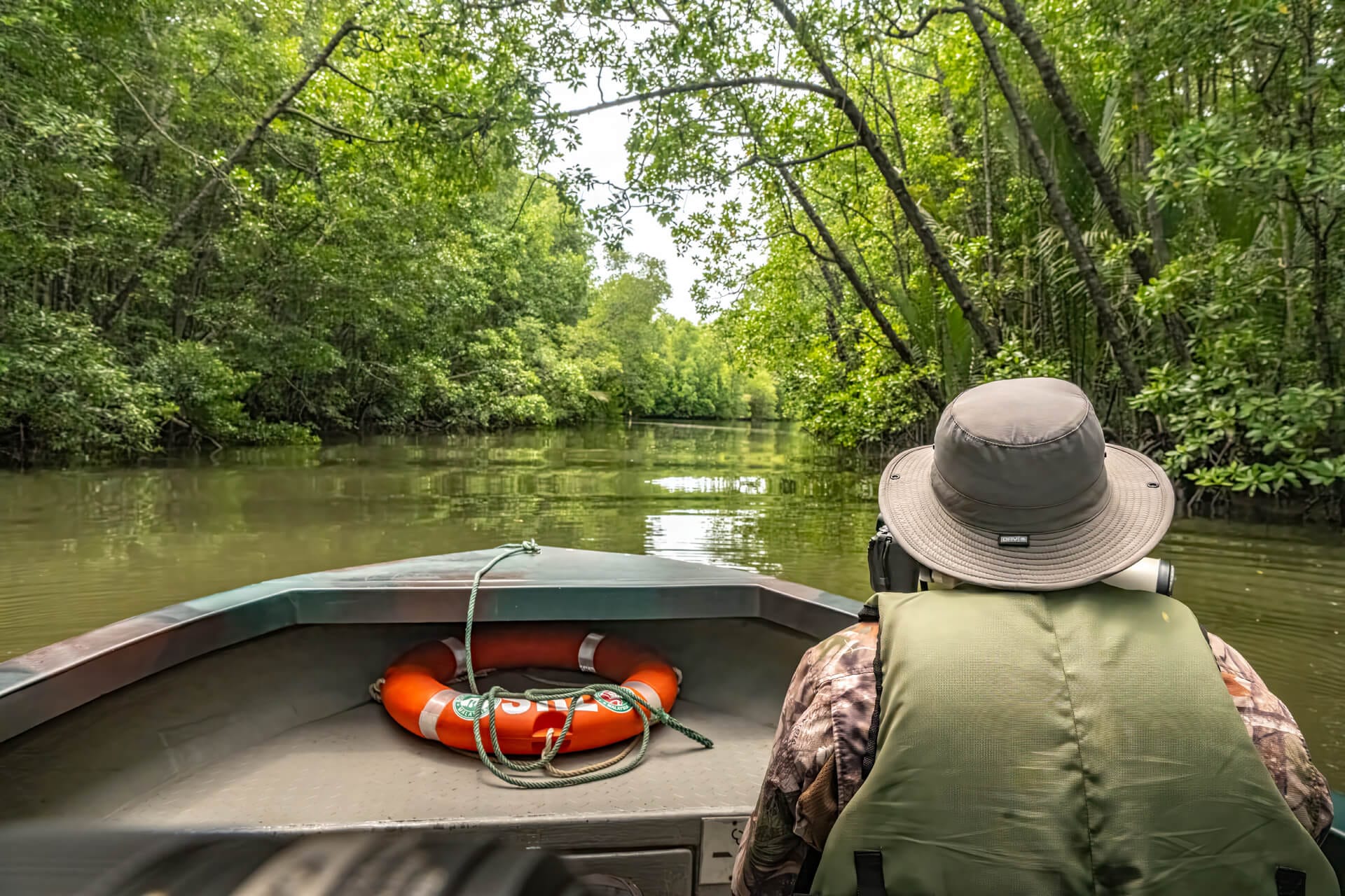 Guide leading a river cruise at Utan Rainforest Lodge