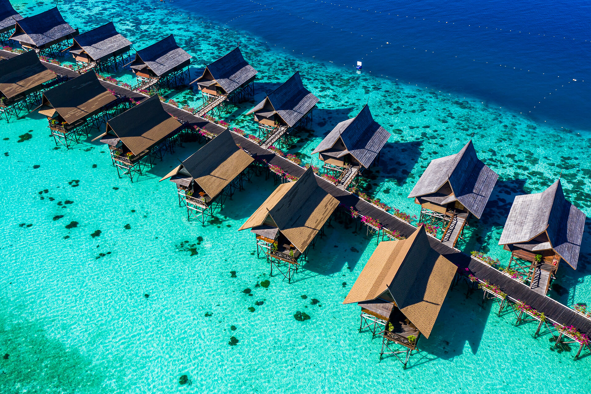 Sipadan Kapalai Dive Resort, water chalets on stilts over a turquoise reef flat